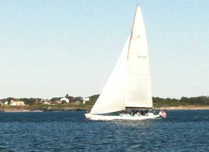 One of the several classic America's Cup veterans thrills a crew of tourists out for a day-sail.