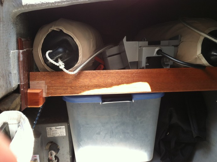 The formerly open space under the cockpit now has roomy shelves on each side for stowing fender, outboard and other gear.