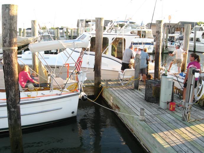 With crew hustling in several directions at once, the boat at the tee-head made ready for an overnight fishing excursion.