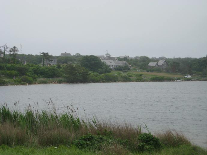 Homes shrouded in morning mist look out over a pond on the north end of the island.