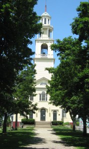 The first Unitarian Church in the US stands tall on a city hill.