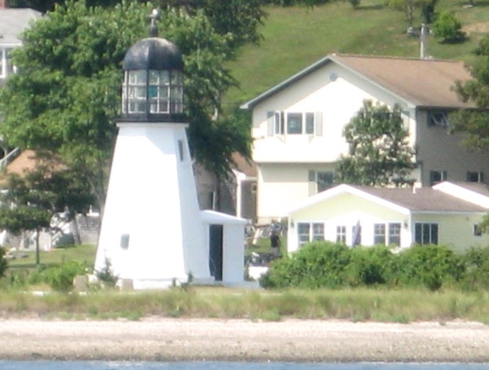 Sandy Point Light sits among beach front homes on Prudence Island.