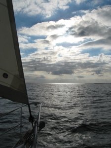 Steadfast sails toward a mottled sky over the Neuse.