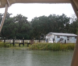 A steady rain rinses the boat and runs off the Bimini .