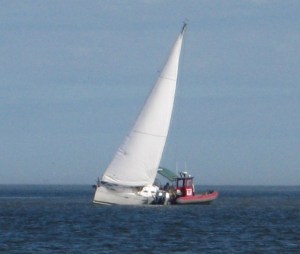 TowBoat tries to help a big Beneteau sloop hard aground off Jekyll Point.