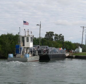 Cars and pedestrians board the barge ferry to Don Pedro.